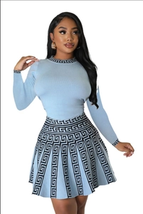Detail shot of blue knitted dress with Greek Meander pattern on collar and cuffs