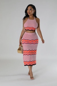 Detail of pink knit two-piece set featuring zigzag patterns and halter neck design