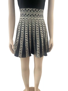Detailed view of knitted dress featuring classic Greek Key pattern and high-waist A-line cut