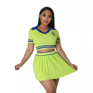 Women's two-piece knit set featuring short sleeve cropped polo top and pleated mini skirt