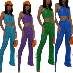 Collage of hollow knit two-piece sets with crop tops and flare pants in four vibrant colors