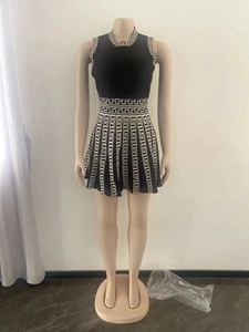 Detail of knit sleeveless dress featuring black and white geometric Greek key patterns
