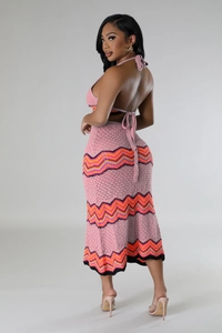 Close-up of pink crochet two-piece set featuring wavy knit patterns and halter neckline