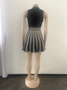 Detail of knit sleeveless dress with greca pattern border and keyhole back closure