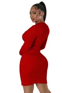 Detail view of red ribbed knit dress showing slim fit design from a side-back angle