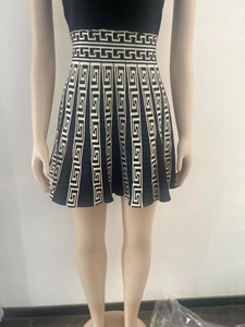 Detail of knit high-waisted skirt featuring black and white Greek key pattern textures