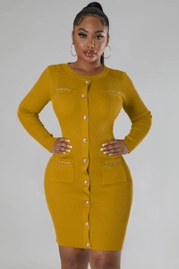 Detail of ochre knit dress featuring decorative gold buttons and metal chain pockets