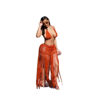 Detail of orange crochet two-piece beach set with long tassel fringe and openwork knit