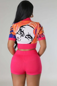 Detail of pink knitted short set with graphic cartoon face jacquard on the back