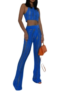 Detail of electric blue knit set showing ripped hollow-out texture on crop top and pants