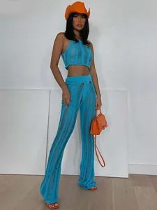 Detail of blue hollow-out knit two-piece set featuring crop top and flared pants