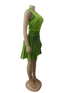 Detail of neon green knit two-piece set featuring black Greek meander pattern texture