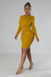 Detail of mustard yellow ribbed knit dress featuring gold chain pocket accents