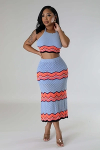 Detail of light blue crochet knit two-piece set featuring colorful chevron pattern edges