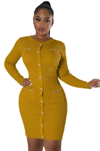 Close-up of mustard knit dress featuring decorative gold chain pockets and metal buttons