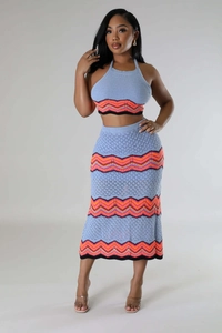 Detail of light blue knit crop top and skirt with colorful wavy pattern texture