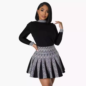 Women's two-piece knitted set with long sleeve top and pleated skirt in Greek key pattern