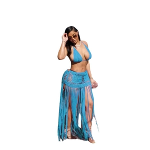 Detailed knit texture and long tassel fringe of this bright blue crochet beach skirt