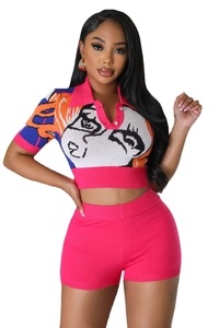 Detail of fuchsia knit set featuring abstract face pattern and elastic high waist shorts