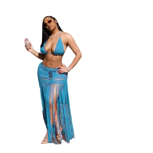 Detail of blue crochet boho beach set showing long fringe tassels on high waist skirt