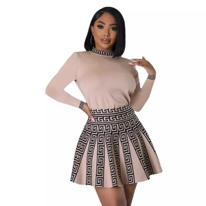 Women's beige knit two-piece set with pleated skirt and black geometric Greek key pattern