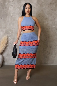 Detail of blue knitted two-piece set featuring wave patterns and halter crop top texture