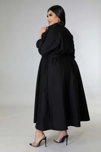Back view of a plus-size black long-sleeve shirt dress with cinched waist and pleated skirt