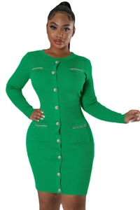 Detailed close-up of green ribbed knit dress with gold chain accents and buttons