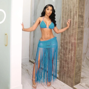 Detail of blue crochet three-piece bikini set with long fringe skirt and tassel design