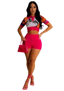 Detail of hot pink knit crop top featuring pop art eye graphic and matching shorts