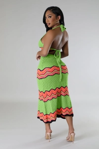 Detail of green crochet two-piece set featuring vibrant zigzag patterns and knit texture