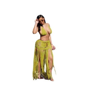 Detail of hand-crocheted grass green bikini top and hollow skirt with long tassels