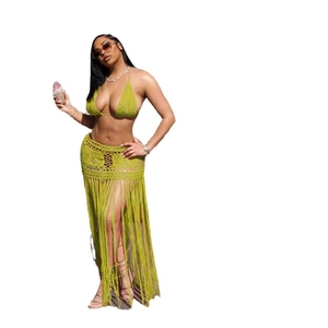 Detail view of green crochet two-piece set with long fringe tassels and mesh knit