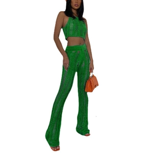 Detail of green knit two-piece set featuring distressed texture and hollow out design