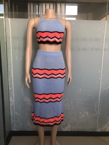 Detail of light blue crochet knit texture on bohemian two-piece crop top and midi skirt
