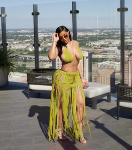 Detailed knit texture of green crochet bikini top and long fringe beach skirt set