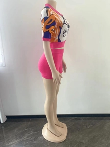 Close-up of the women's knitted set featuring colorful graffiti print crop top and hot pink shorts