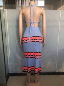 Detail of light blue knit crochet set showing wave pattern on halter top and long skirt