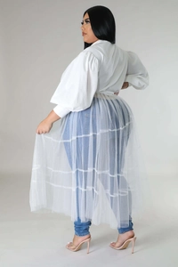 Detail view of white puff sleeve top and layered mesh skirt with back profile details