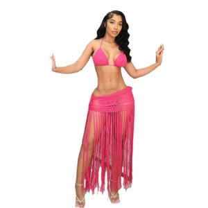 Detail of rose red crochet two-piece beach set featuring long fringe and hollow knit texture