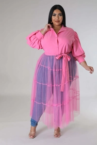 Detail of plus size vibrant pink shirt with puff sleeves and layered mesh wrap skirt