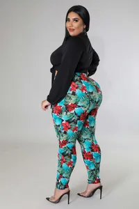 Close-up of plus size set featuring tie-front top and vibrant tropical print pants