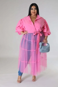 Detail of plus size pink puff sleeve shirt paired with layered mesh skirt and woven bag