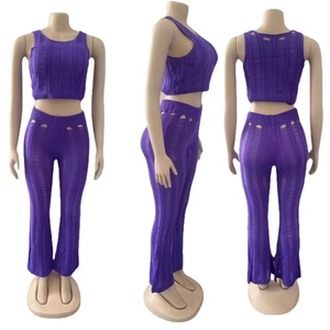 Detail of purple knitted set featuring sleeveless crop top and hollow-out flare trousers