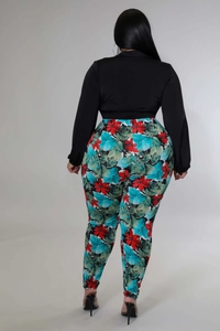 Back view of plus-size wrap top and vibrant tropical floral print slim pants