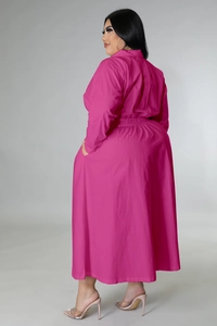 Detail view of the pleated waist and long sleeves on a rose red plus-size shirt dress