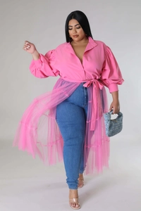 Detail of pink puff sleeve blouse with mesh overlay and blue woven handbag for plus size women