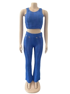 Close-up of bright blue ribbed knit fabric with oval cut-out details on the high-waist pants