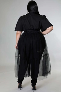 Rear view of plus size black outfit with sheer mesh overlay and long flowing chiffon detail