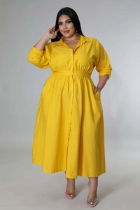 Detail of plus size yellow shirt dress featuring button-down front and waist tie